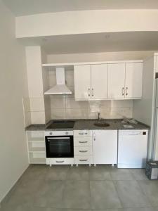 a kitchen with white cabinets and a sink at Avsallar Star Residence in Avsallar
