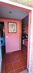 Habitación con puerta rosa y cama en Casa do Monte, en Castro Daire