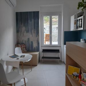 a living room with a table and a window at Acla Apartments in Manarola