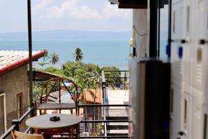 a balcony with a view of the ocean at Joy Camping & Rooms in Haad Rin