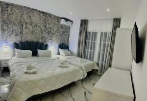 Postel nebo postele na pokoji v ubytování UJVARA HOTEL