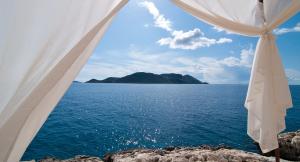 a view of the ocean from a white tent at Lycia Hotel in Kaş