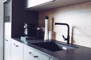 a kitchen with a sink and a black counter top at Padaster 1262 in Trins