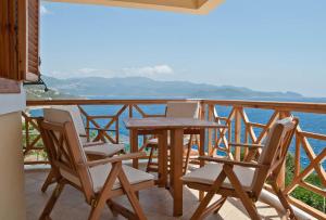 a table and chairs on a balcony overlooking the water at Lycia Hotel in Kaş