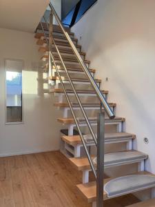 a metal staircase with wooden treads in a house at Dach-Maisonette "Villa Karola" an der Therme in Bad Sulza +8 photos