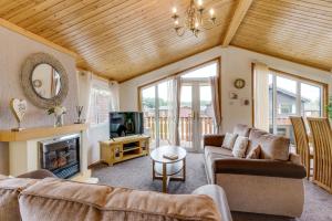 a living room with a couch and a fireplace at Silverdale 21 in Warton