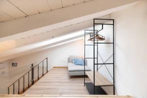 a staircase in a loft with a glass shelf at L'alba di ortigia a due passi dal mare in Siracusa