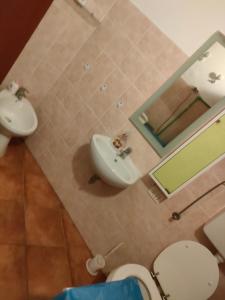 a bathroom with a sink and a toilet and a mirror at Mini appartamento in Livorno