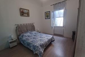 sypialnia z łóżkiem i oknem w obiekcie maison 4 à 6 personnes proche village w mieście Pélissanne