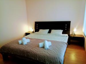 a bedroom with a bed with two pillows on it at Family Apartament Crown Pool&Sea - BastetBS in Sveti Vlas
