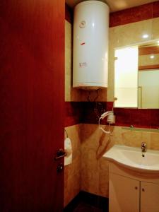 a bathroom with a sink and a cabinet and a mirror at Family Apartament Crown Pool&Sea - BastetBS in Sveti Vlas