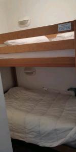 a bedroom with two bunk beds in a room at Location appartement à Bonascre in Ax-les-Thermes