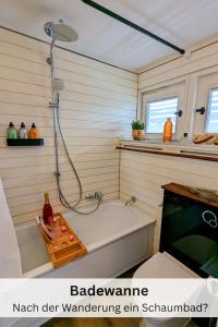 a bathroom with a shower and a bath tub at Black Forest Stay - Apartment Hirschperle in Sasbachwalden