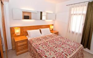 a bedroom with a bed with a red and white blanket at Lycia Hotel in Kaş