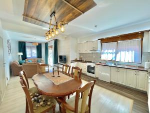 a kitchen and living room with a table and chairs at Villa Serenity Budva in Budva