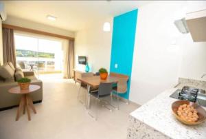a kitchen and living room with a table and a couch at Ilhas do Lago Eco Resort in Caldas Novas