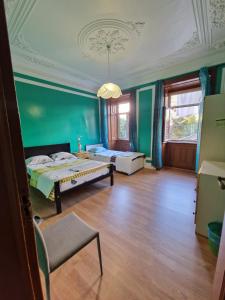Pokój z 2 łóżkami i zieloną ścianą w obiekcie Alojamento Local Private Accommodation w Lizbonie