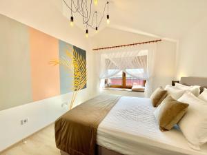 a bedroom with a large bed and a window at Villa Serenity Budva in Budva