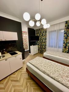 a large room with two beds and a kitchen at Apartamenty Green in Stargard