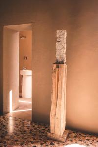 a bathroom with a stone pillar on the wall at Palazzo del Settecento in Ravenna