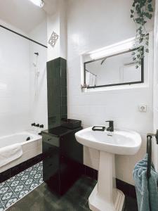 a white bathroom with a sink and a mirror at El Segon Pis in Berga +22 photos
