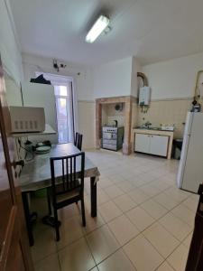a kitchen with a table and chairs in a room at Alojamento Local Private Accommodation in Lisbon