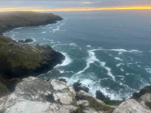 an aerial view of the ocean from a cliff at Syds Corner bell tent in St. Just +7 photos