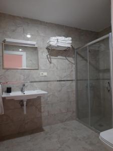 a bathroom with a shower and a sink and a mirror at Z&B HOME in Nevsehir