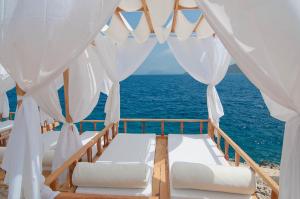 a bedroom with a view of the ocean at Lycia Hotel in Kaş