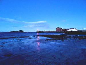 a view of the beach at night at The Beach Pad North Berwick in North Berwick