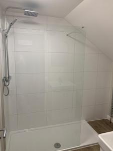 a shower with a glass door in a bathroom at The Beach Pad North Berwick in North Berwick