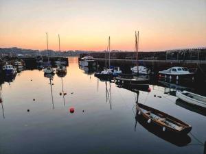 a group of boats are docked in a harbor at The Beach Pad North Berwick in North Berwick