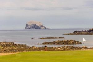 a golf course with an island in the water at The Beach Pad North Berwick in North Berwick