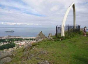 a person standing on top of a hill with a monument at The Beach Pad North Berwick in North Berwick