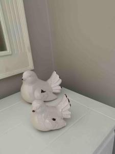 two white birds sitting on top of a table at The Beach Pad North Berwick in North Berwick