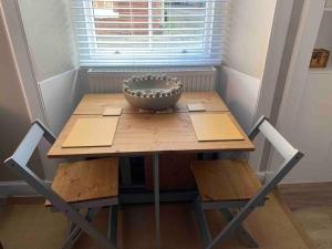 a wooden table with a bowl on top of it at The Beach Pad North Berwick in North Berwick