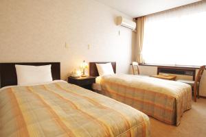 Postel nebo postele na pokoji v ubytování Ichirino Kogen Hotel Roan