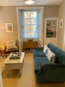 a living room with a couch and a coffee table at The Beach Pad North Berwick in North Berwick