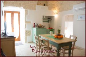 a kitchen with a table with oranges on it at "B&B La Lanterna" in Alberobello