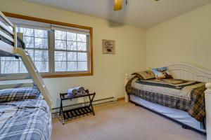 a bedroom with two beds and a bunk bed at Hot Tub and Game Room Cozy Big Bass Lake Home! in Gouldsboro +34 photos