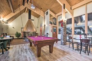 a pool table in a room with a fireplace at Cozy Big Bass Lake Home with Hot Tub and Game Room! in Gouldsboro