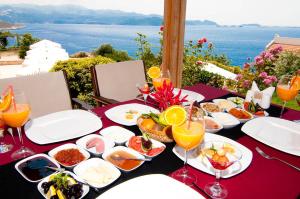 a table with plates of food and glasses of wine at Lycia Hotel in Kaş