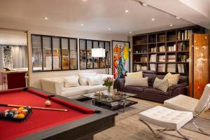a living room with a red pool table in the middle at Maison Lavaud in Paris