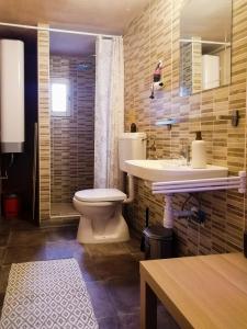 a bathroom with a toilet and a sink at Mi Casa Vendégház - Apartments in Eger