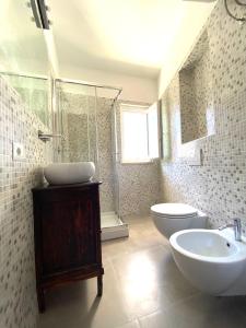 a bathroom with a sink and a toilet and a shower at La Stella Marinella in Santa Marinella