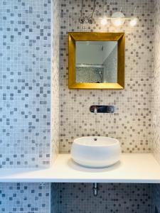 a bathroom with a white sink and a mirror at La Stella Marinella in Santa Marinella