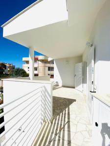 a white house with a white fence at La Stella Marinella in Santa Marinella