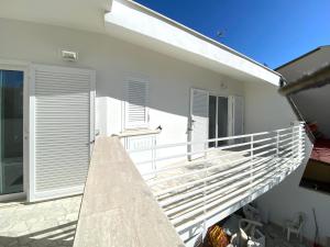 a staircase leading up to a white house at La Stella Marinella in Santa Marinella
