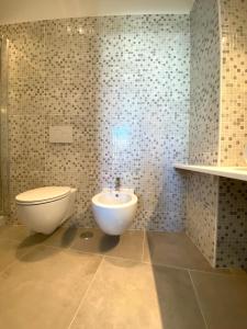 a bathroom with a toilet and a bidet and a sink at La Stella Marinella in Santa Marinella