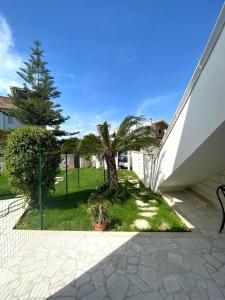 a palm tree in a yard next to a building at La Stella Marinella in Santa Marinella